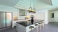 The kitchen plus breakfast bar
